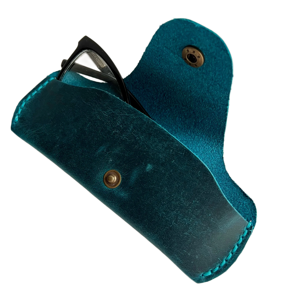 Small Soft Leather Eye Glasses Case in Teal, open, angled top view with black-framed eyeglasses inside