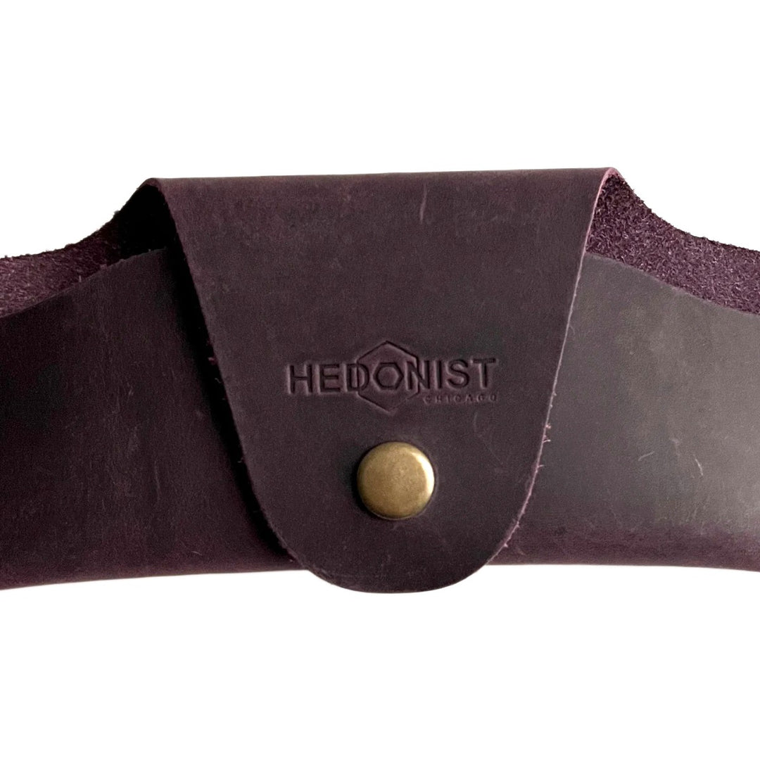 Small Soft Leather Eye Glasses Case in Plum, closed, front view with embossed Hedonist logo and snap closure