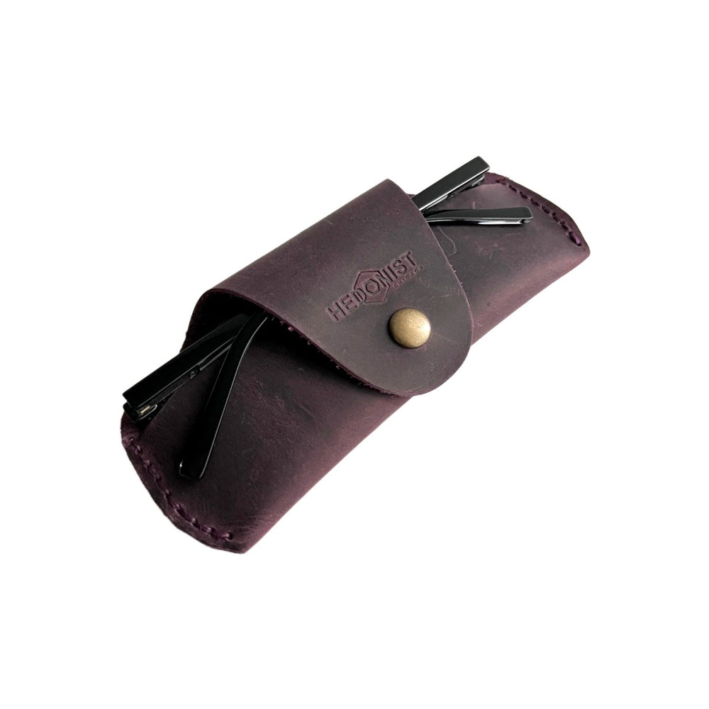 Small Soft Leather Eye Glasses Case in Plum, angled view with sunglasses temples visible poking out both sides
