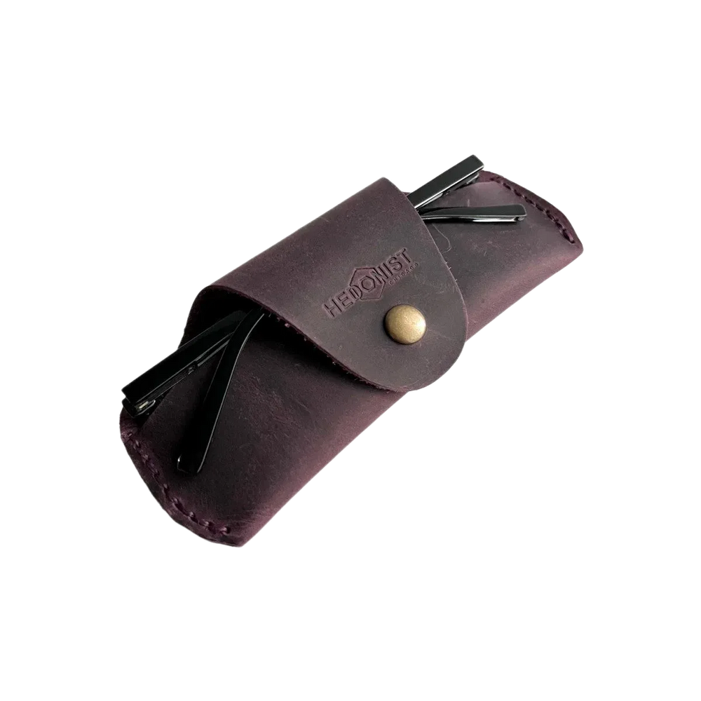 Small Soft Leather Eye Glasses Case in Plum, angled view with sunglasses temples visible poking out both sides