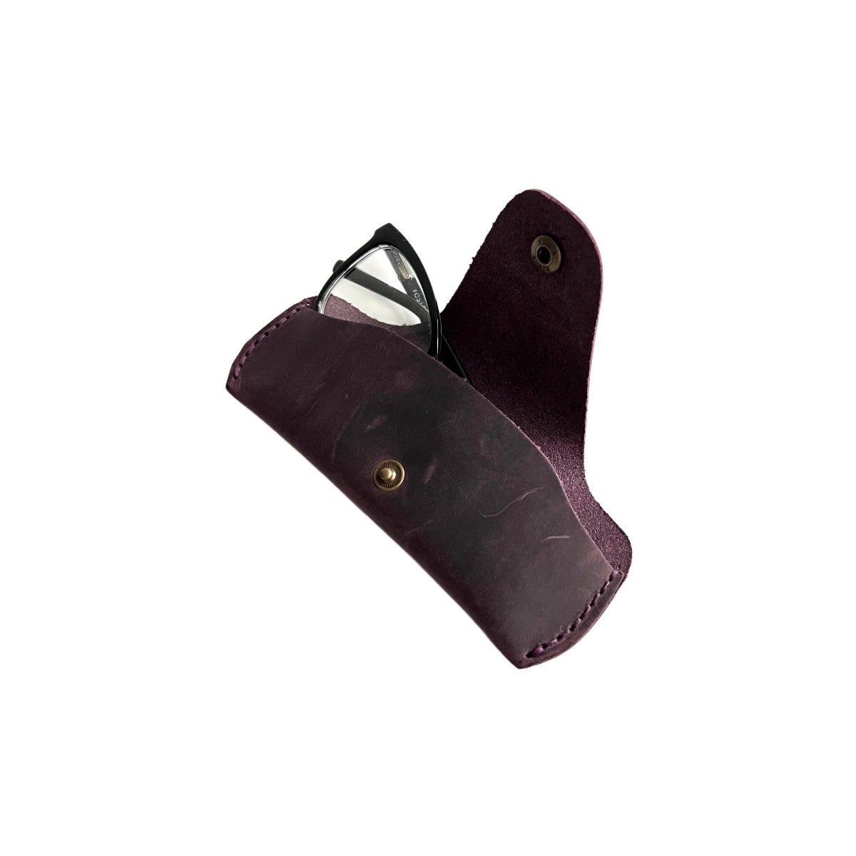 Small Soft Leather Eye Glasses Case in Plum, angled view with black-framed eyeglasses tucked inside