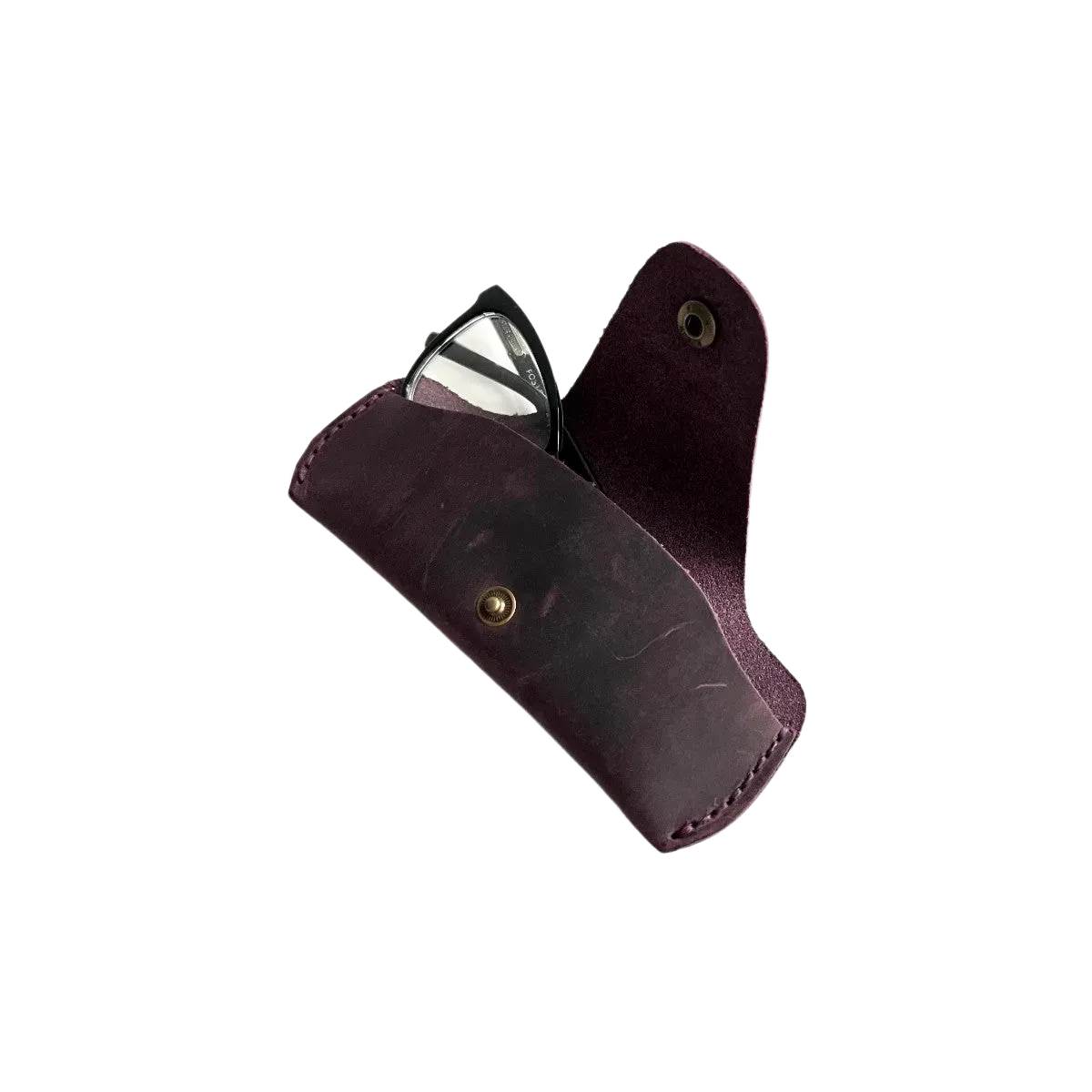 Small Soft Leather Eye Glasses Case in Plum, angled view with black-framed eyeglasses tucked inside