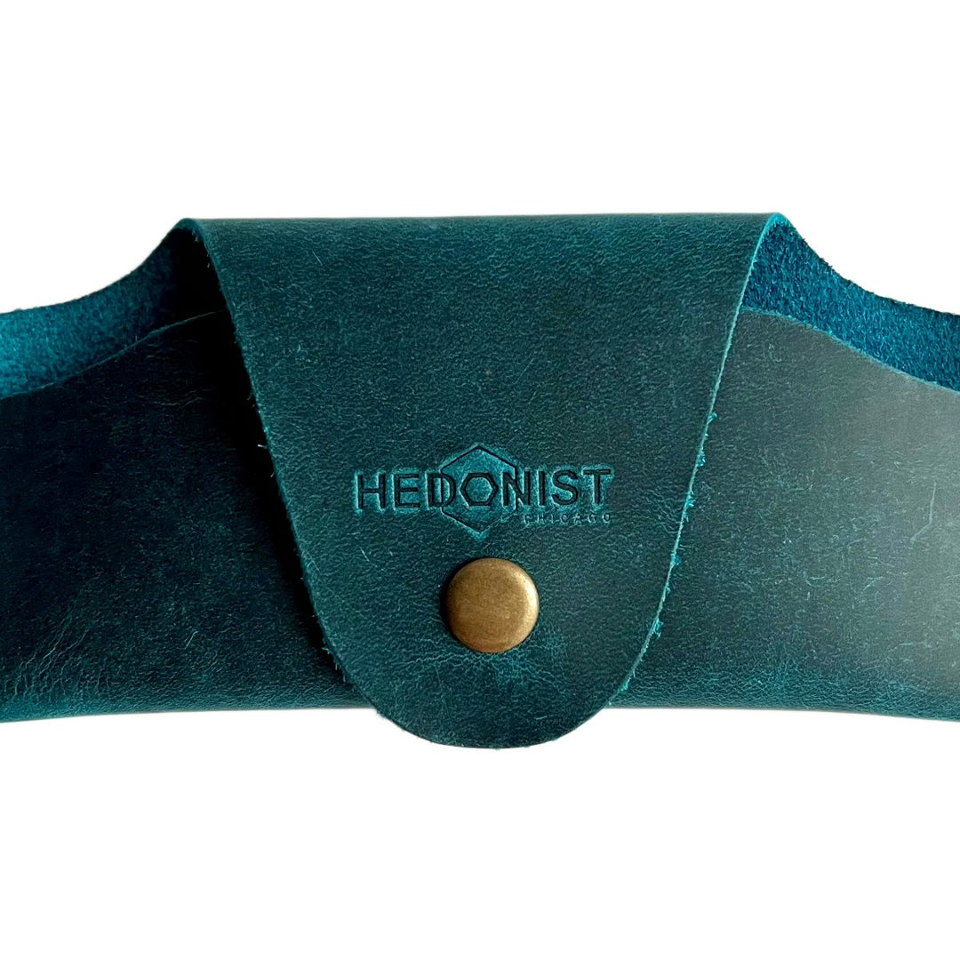 Small Soft Leather Eye Glasses Case in Teal, closed, front view with embossed Hedonist logo and snap closure
