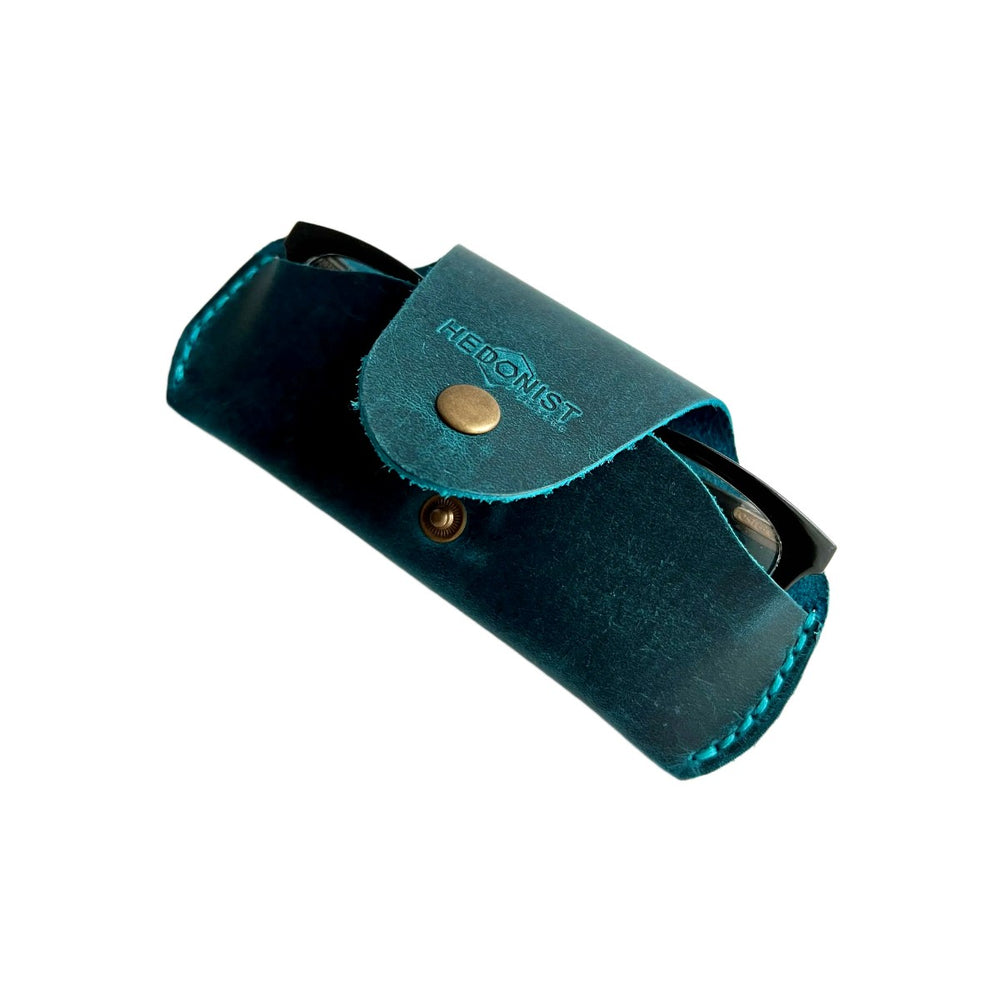 Small Soft Leather Eye Glasses Case in Teal, angled view with black-framed eyeglasses tucked inside
