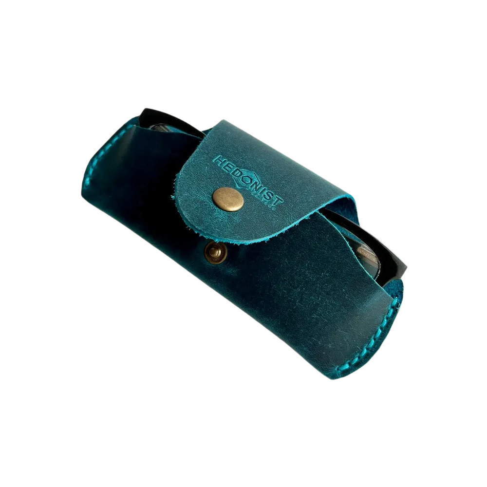 Small Soft Leather Eye Glasses Case in Teal, angled view with black-framed eyeglasses tucked inside