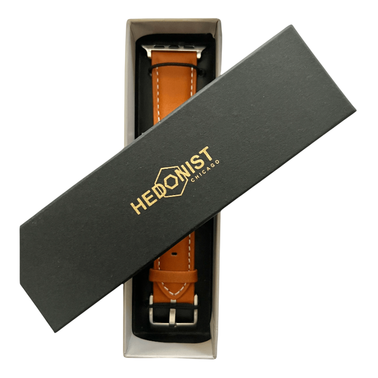 Tan padded leather Apple Watch band, presented in gift box