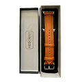 Tan padded leather Apple Watch band, packaging close-up