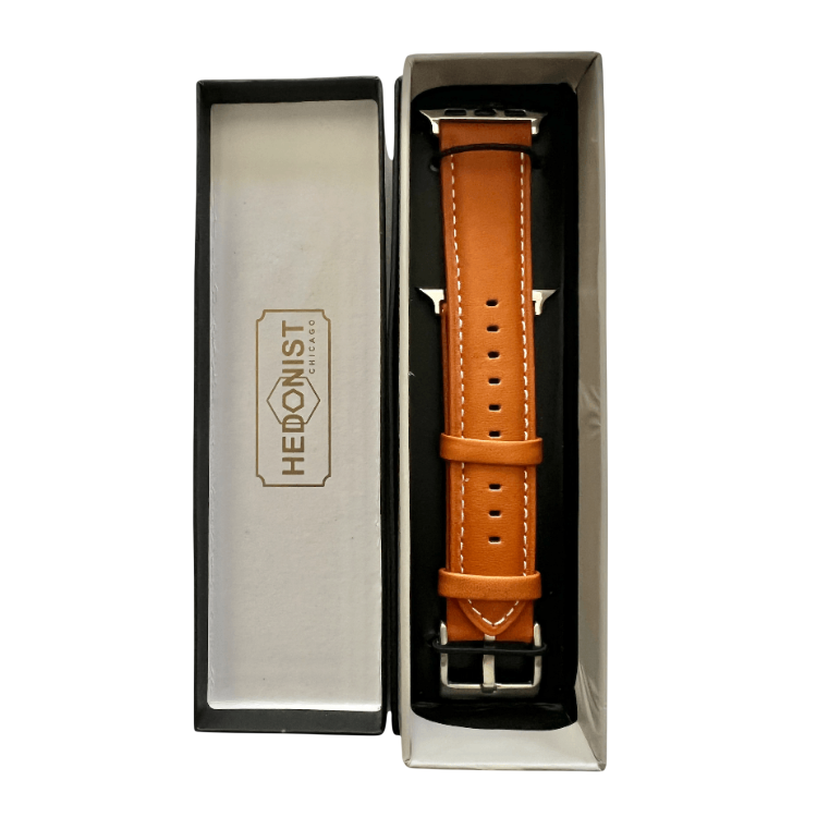 Tan padded leather Apple Watch band, packaging close-up