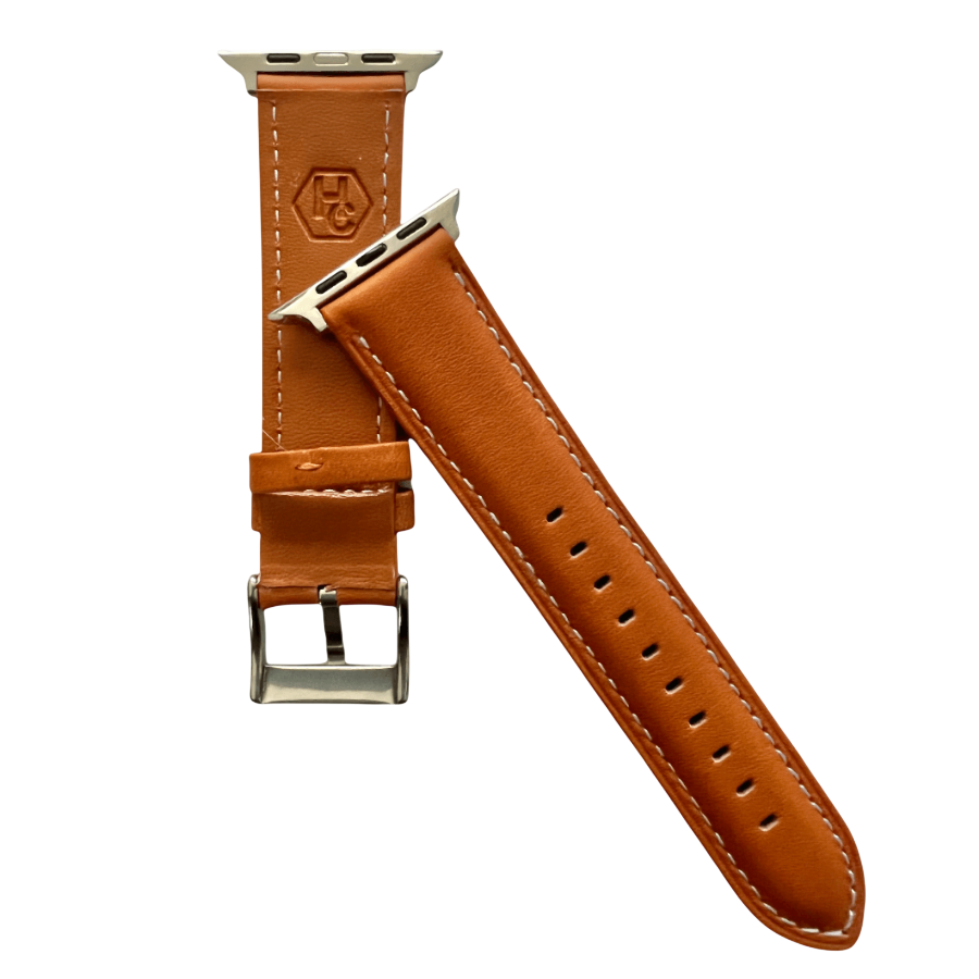 Tan padded leather Apple Watch band, texture and buckle detail close-up
