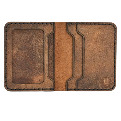 Handmade tan pull-up leather bifold wallet with ID slot, open showing cards