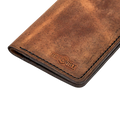 Handmade tan pull-up leather card holder, close-up of branding detail