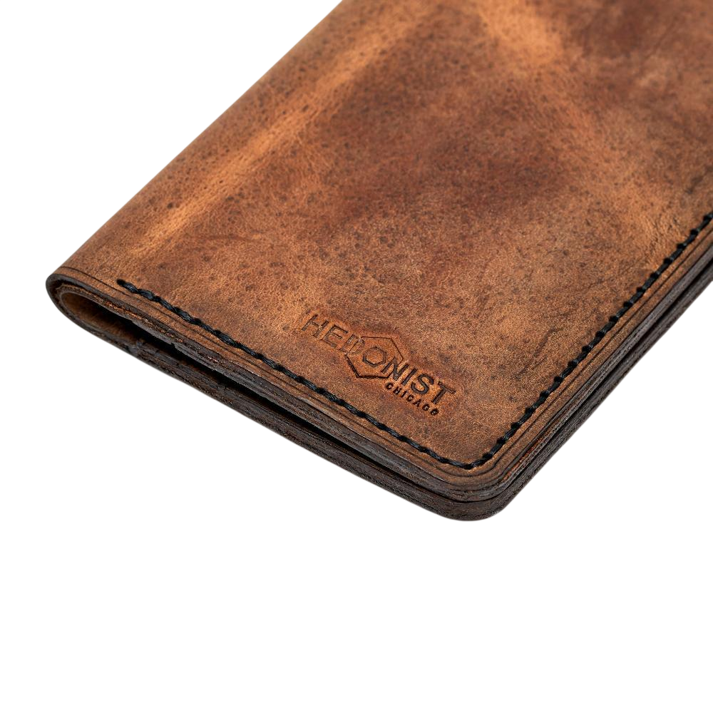 Handmade tan pull-up leather card holder, close-up of branding detail