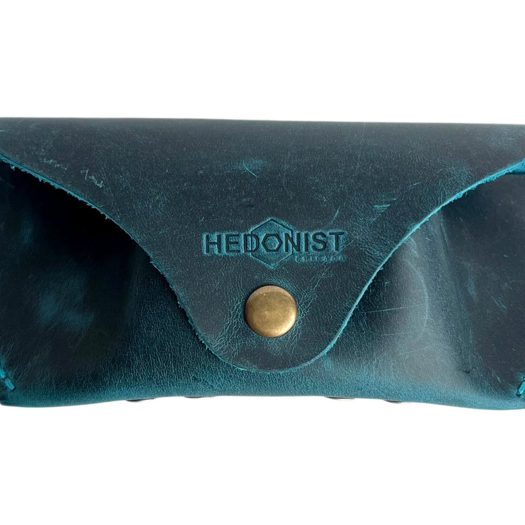 Soft Leather Eye Glasses Case in Teal, closed, front view with embossed Hedonist logo and snap closure