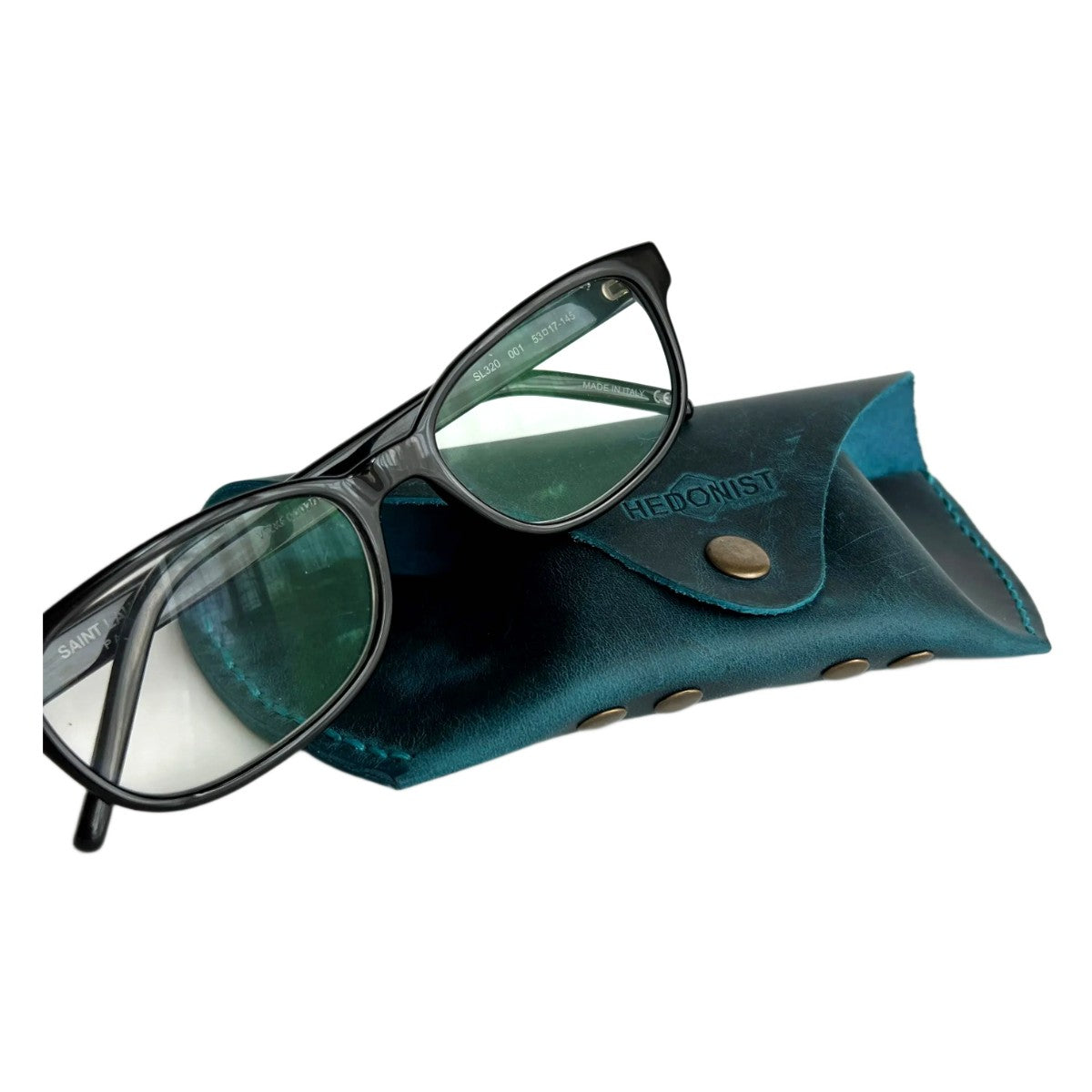 Soft Leather Eye Glasses Case in Teal with black-framed eyeglasses resting on top