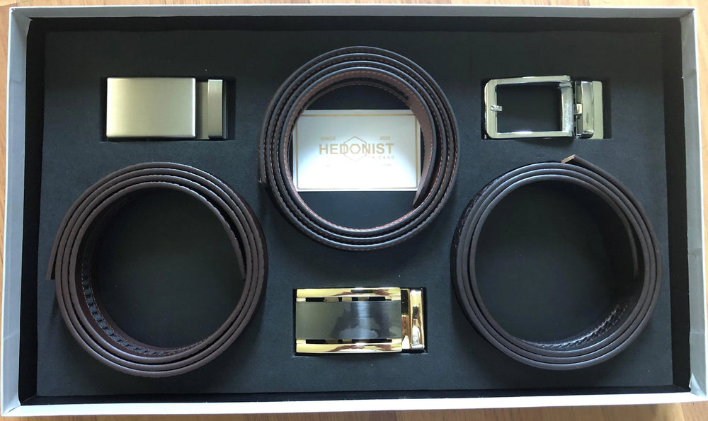 Three leather belts gift set, close-up view of box contents