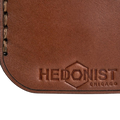 Hedonist Chicago whisky key chain in whisky, slim profile, full grain leather, flat lay view
