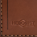 Hedonist Chicago whisky luggage tag in whisky, with strap, full grain leather, flat lay view