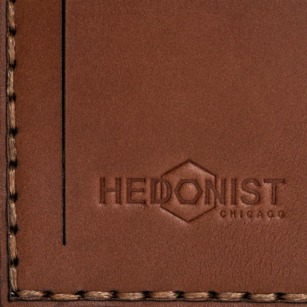 Hedonist Chicago whisky luggage tag in whisky, with strap, full grain leather, flat lay view