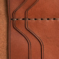 Handmade light mahogany leather card holder, close-up of leather texture and stitching