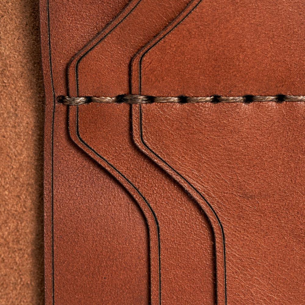 Handmade light mahogany leather card holder, close-up of leather texture and stitching