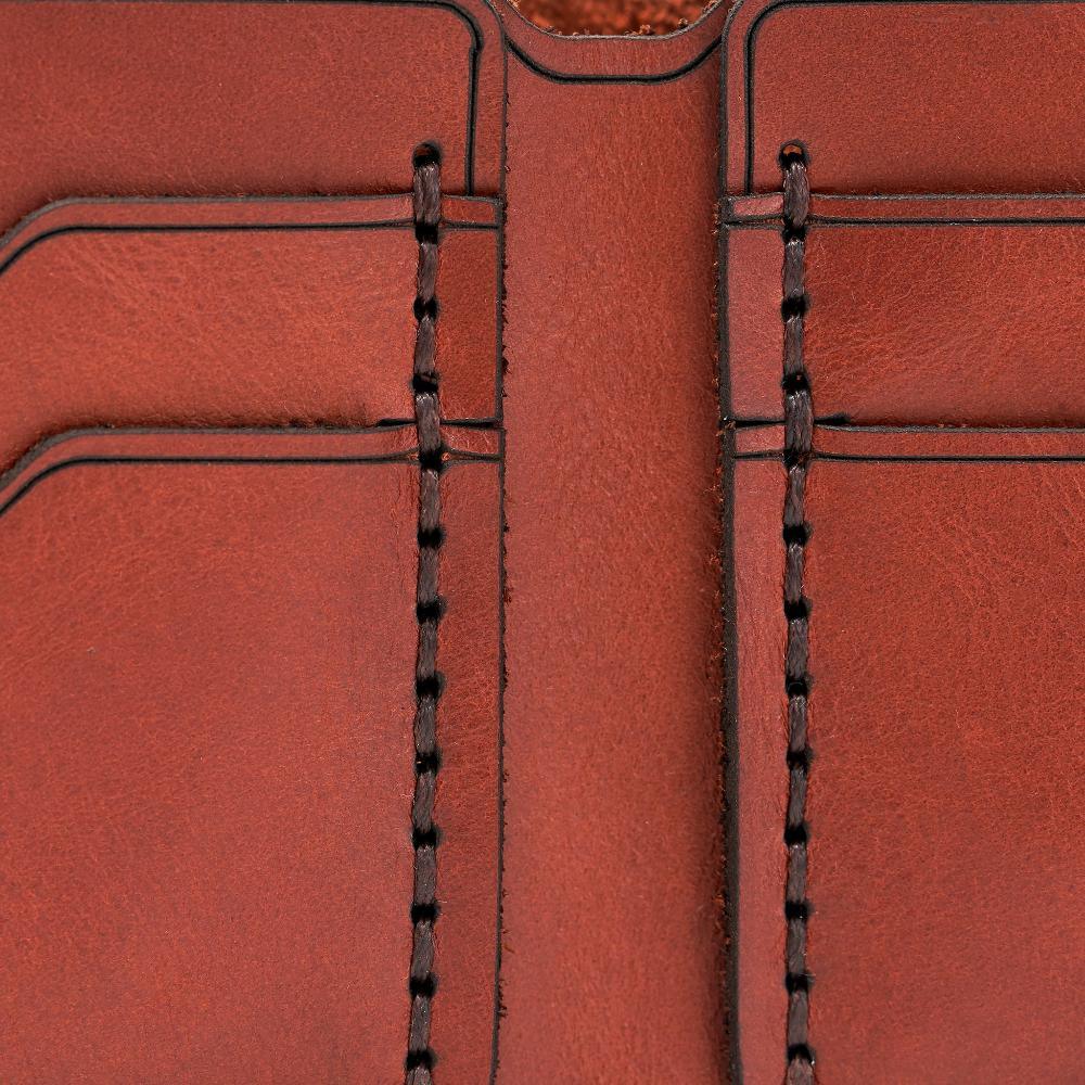 Handmade red brick leather bifold wallet, close-up of leather texture and stitching