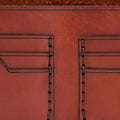 Handmade red brick leather bifold wallet, close-up of leather texture and stitching