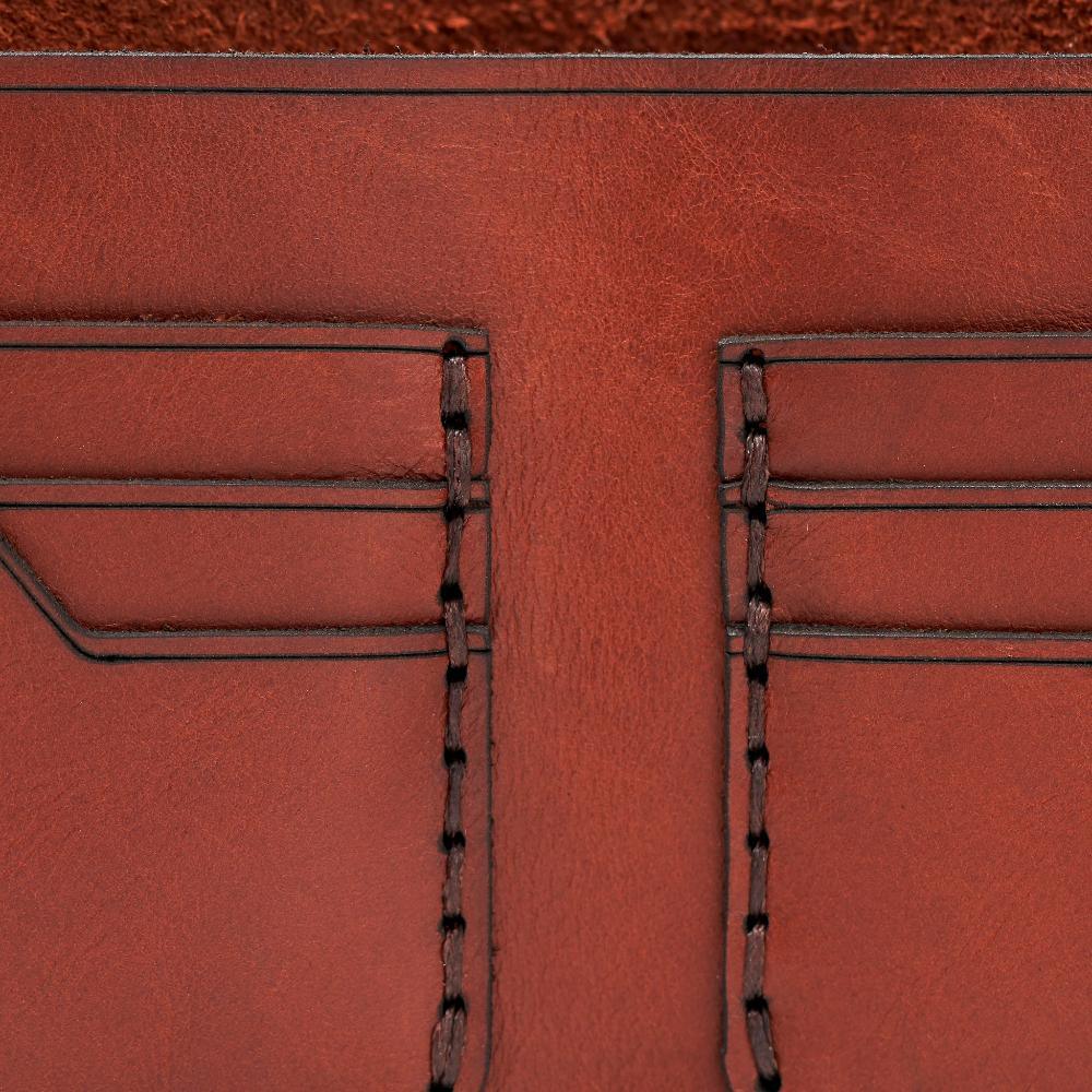Handmade red brick leather bifold wallet, close-up of leather texture and stitching
