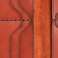 Handmade red brick leather card holder, close-up of leather texture and stitching