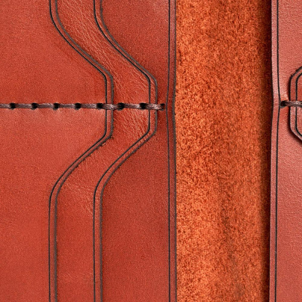 Handmade red brick leather card holder, close-up of leather texture and stitching