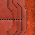 Handmade red brick leather card holder, close-up of leather texture and stitching