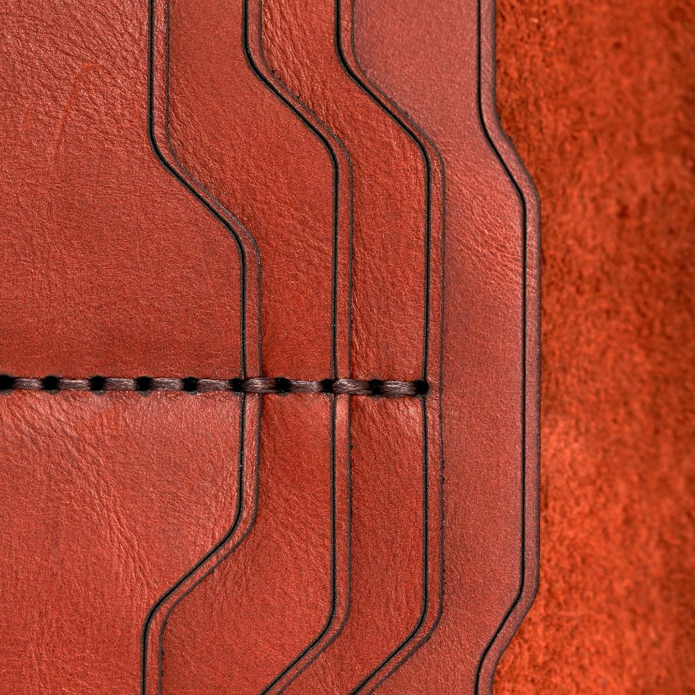 Handmade red brick leather card holder, close-up of leather texture and stitching
