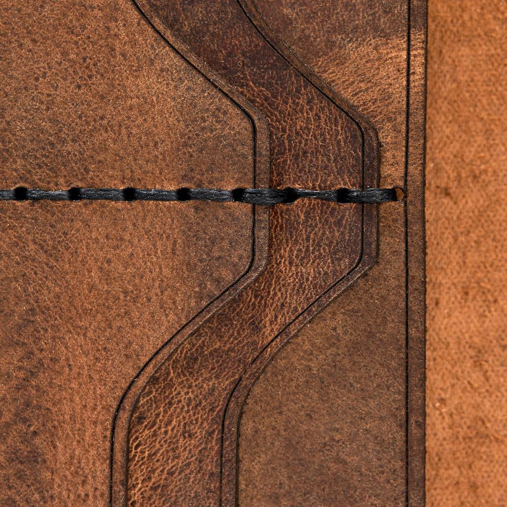 Handmade tan pull-up leather card holder, close-up of leather texture and stitching