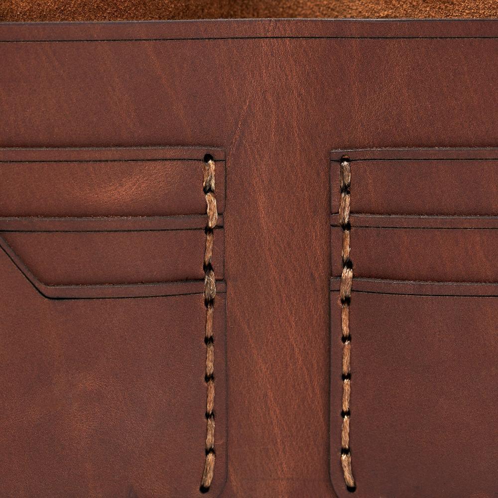 Handmade whisky pull-up leather bifold wallet, close-up of leather texture and stitching